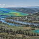 Satellite, drone and ground-based sensors collecting complementary measurements over a European river valley, with highlighted areas showing the different observation scales.